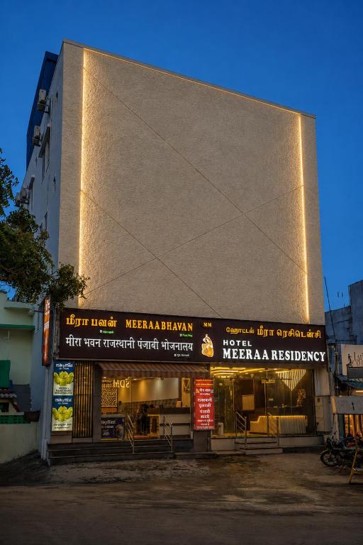 a building with signs on the side of it at Meeraa Residency in Rāmeswaram