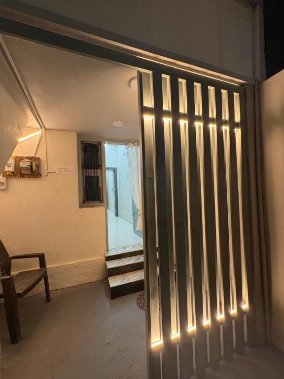 a hallway with a door with lights on it at vMAC in Thiruchendur