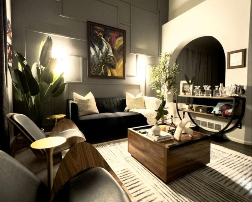 a living room with a couch and a coffee table at The Grand Avora Apartment With 3 Ac And Free Parking in Lahore