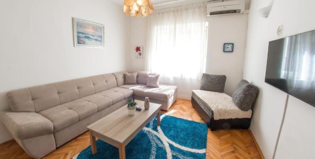 a living room with a couch and a table at Apartment Tiger Lily in Mostar