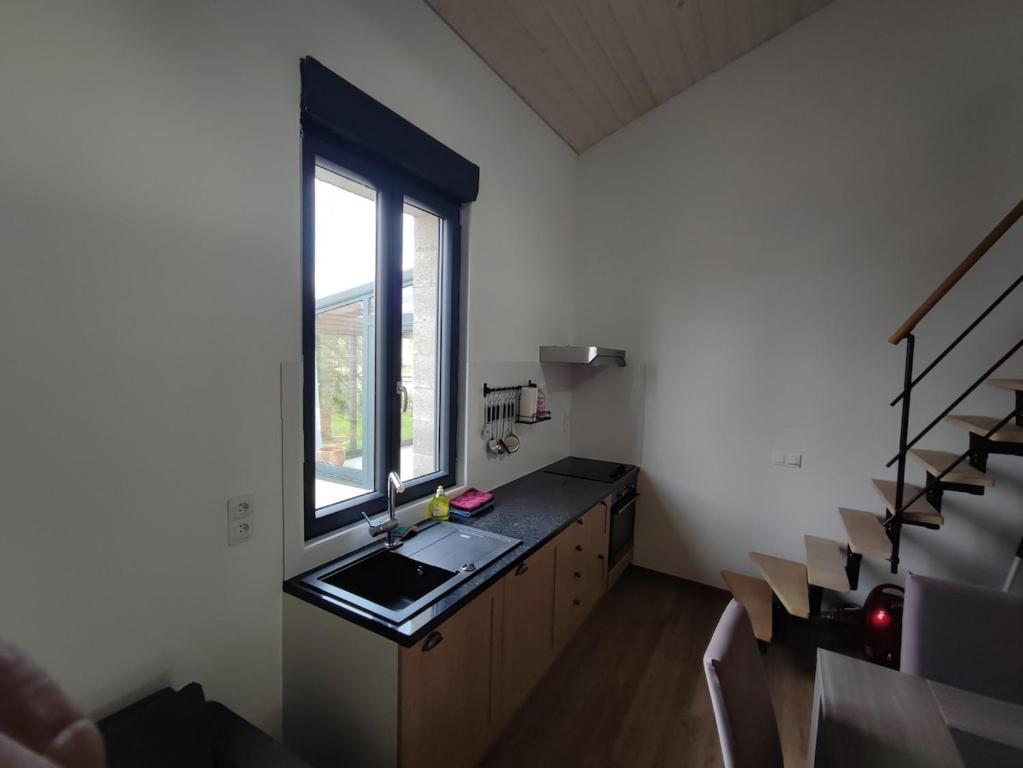 a small kitchen with a sink and a window at Augustobona in Lévigny