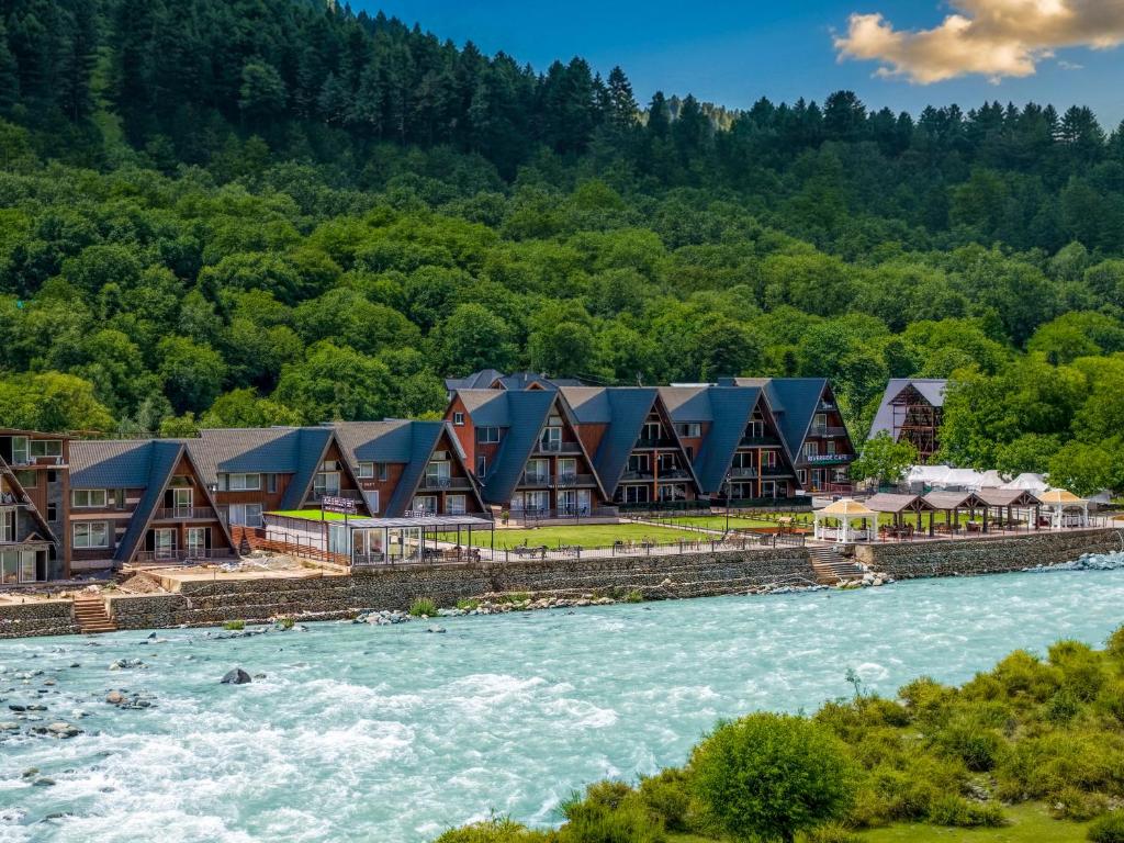 an aerial view of a resort next to a river at Asal Riverside Pahalgam in Pahalgām