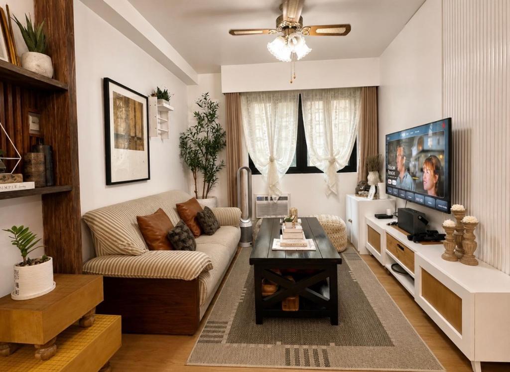 a living room with a couch and a tv at Terravive in Manila