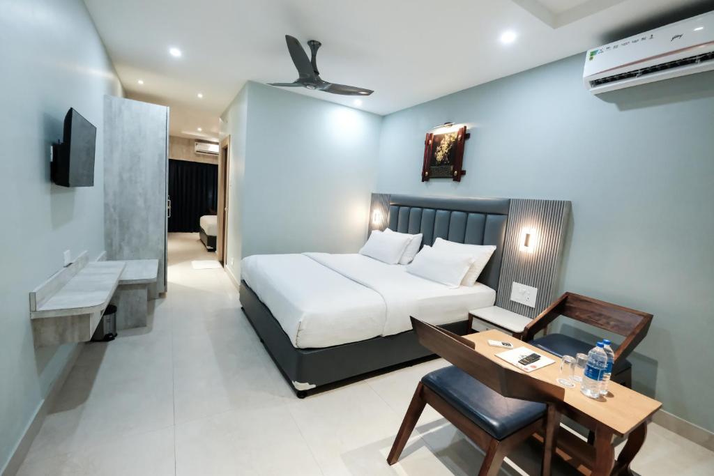 a hotel room with a bed and a desk and a desk at Hotel Lee Garden Near to Blue Flag Beach 500 Mtrs in Puri