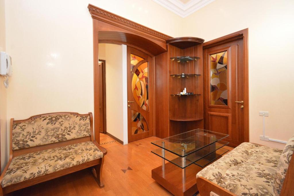 a living room with a couch and a glass table at Tumanyan Guesthouses in Yerevan
