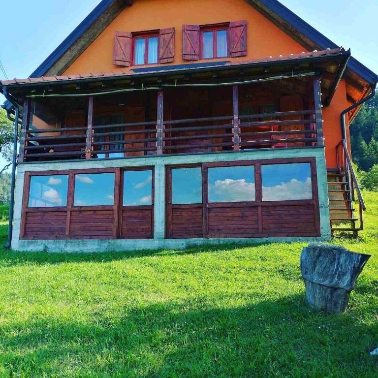 a house with large windows on the side of it at Konak kik in Zaovine