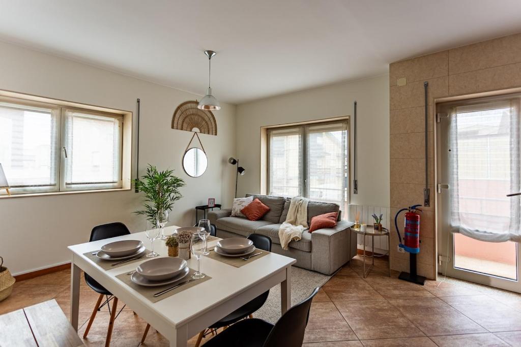 a living room with a table and a couch at Alegria Beach House in Vila do Conde