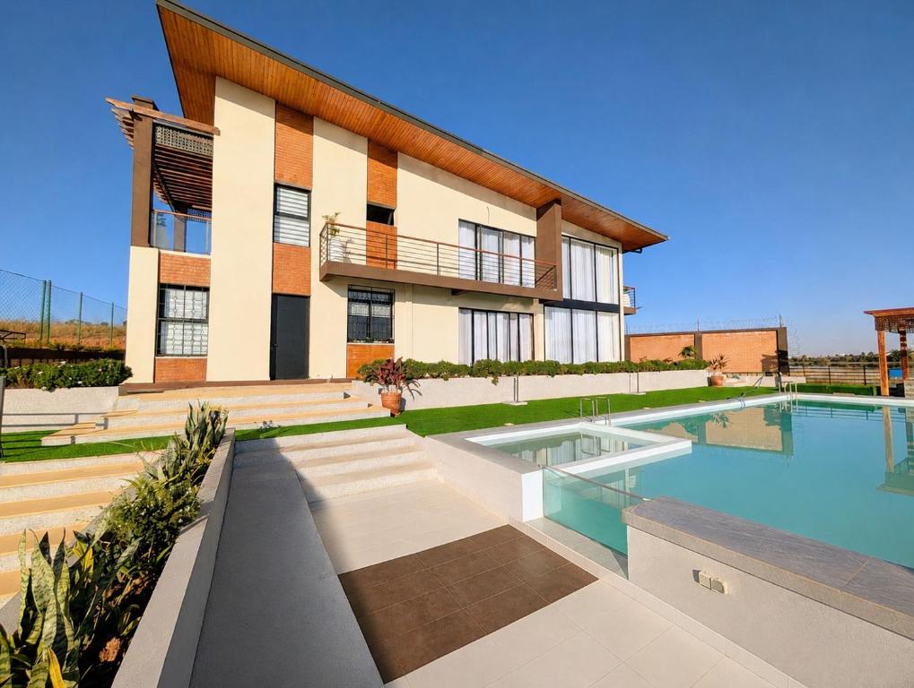 a house with a swimming pool in front of it at Riva guest house in Antananarivo