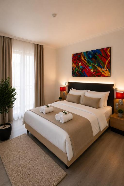 a bedroom with a large bed with two towels on it at M14 Stay Cluj in Cluj-Napoca