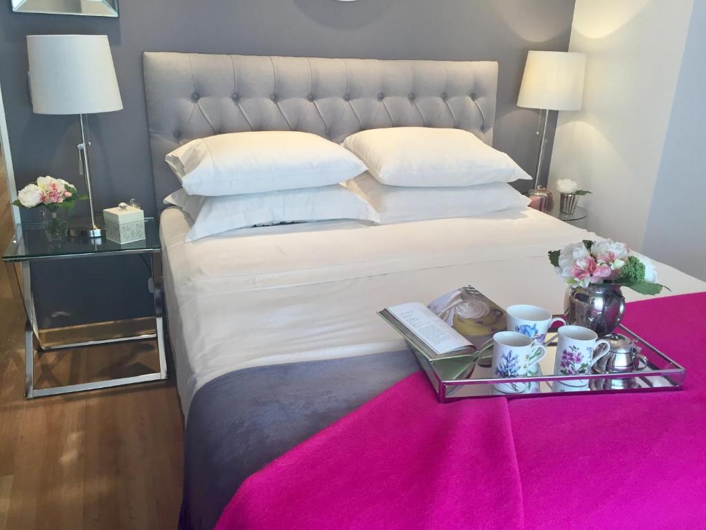 a bedroom with a large bed with a tray on it at Luxury Apartment Tagle in Buenos Aires