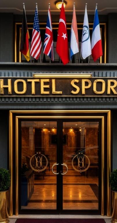 a hotel sign with flags on top of a door at SPOR HOTEL in Ankara