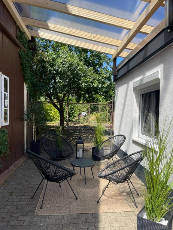 a patio with a table and chairs on a patio at Garten Oase Weisweil in Weisweil