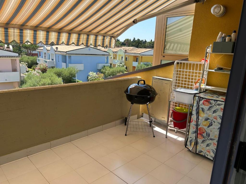 a kitchen with a balcony with a view of a city at Blu 31 Marcelli in Marcelli