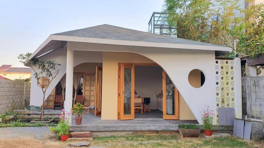 a small house with a porch and a door at Te Retreat in Hà My Tây (2)