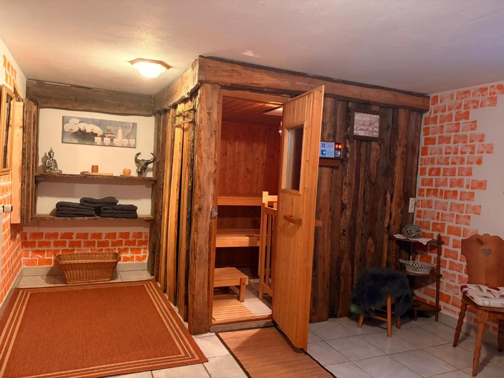 a room with a wooden closet and a brick wall at Ferienhaus Sophia & Ilse in Murau