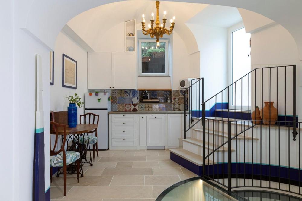 a kitchen with a staircase and a dining room at Circumpiso in Massa Lubrense