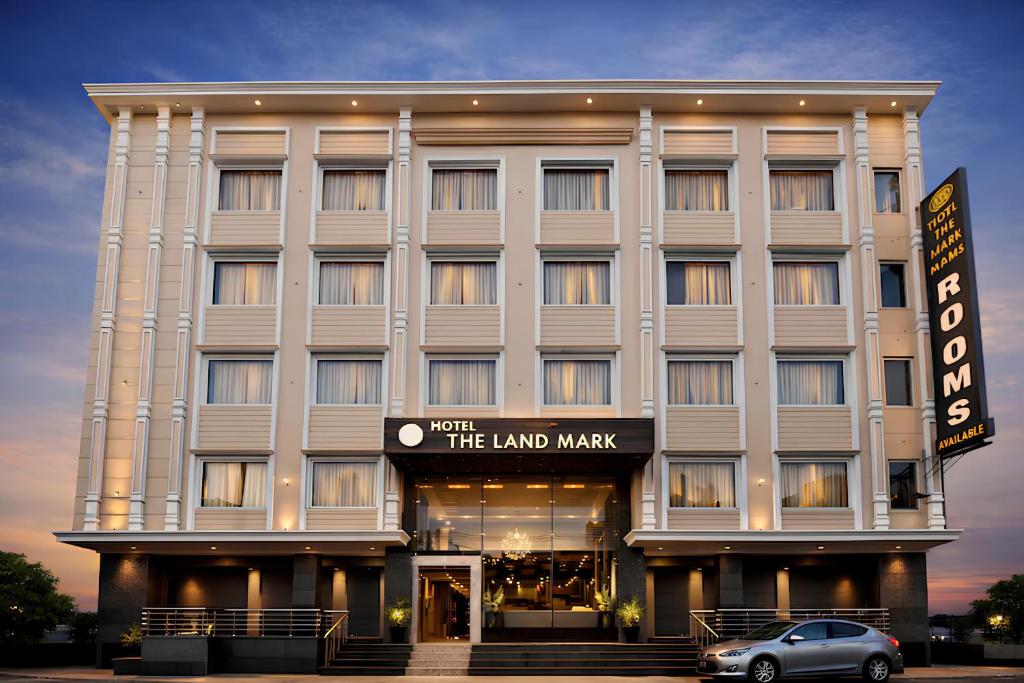 a building with a car parked in front of it at Hotel Landmark Near Golden Temple in Amritsar