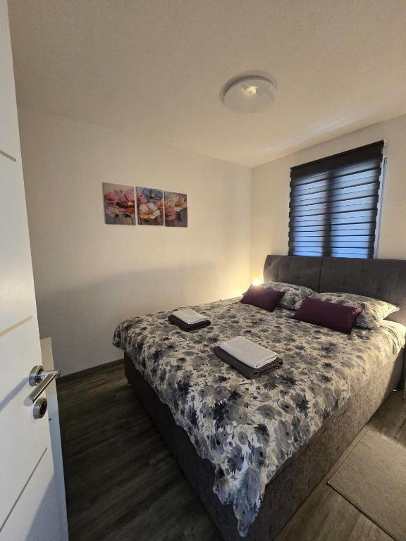a bedroom with a bed with two laptops on it at Tiny House Ciciban - self check in and check out in Otočac