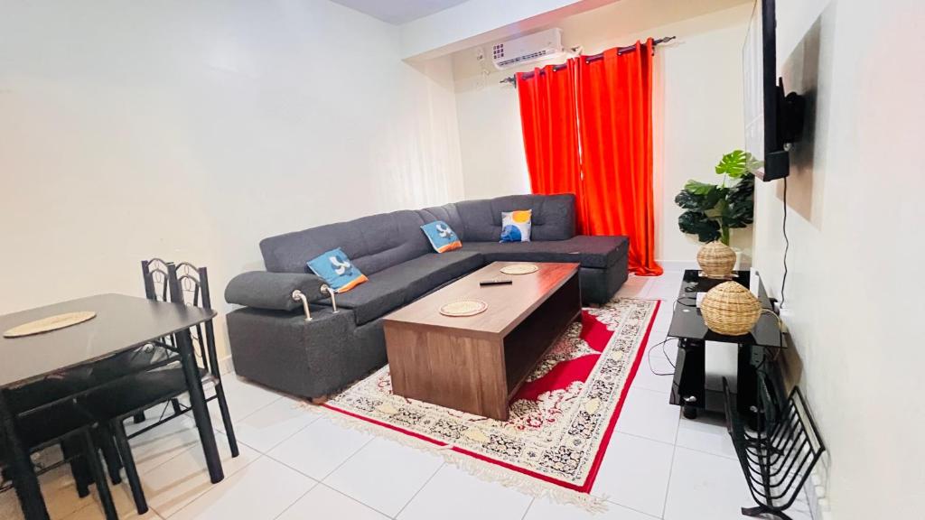 a living room with a couch and a table at 3 bedroom house buxton in Mombasa