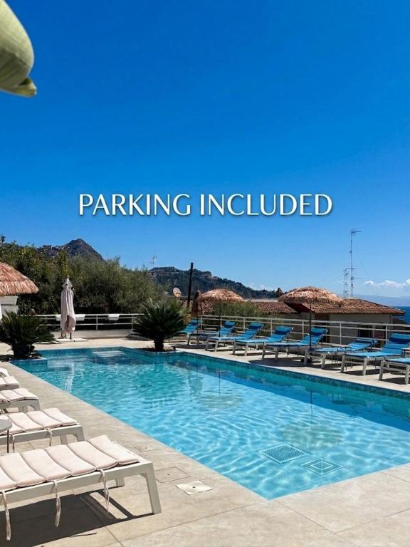 a swimming pool with chaise lounge chairs and the words parking included at IG - "Villa Don Antonio" Apartments in Giardini Naxos