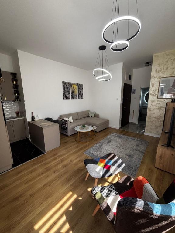 a living room with a couch and a table at Lake&Chill Residence in Palić