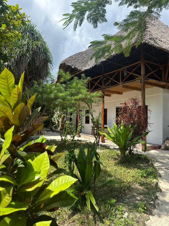 a small house with a thatched roof at Warembo beach Nungwi in Nungwi
