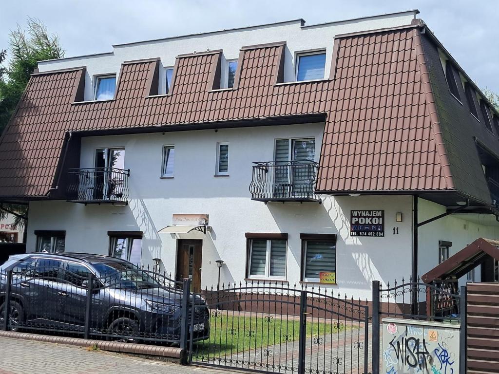 a house with a car parked in front of it at POD BOROWIKIEM in Grzybowo