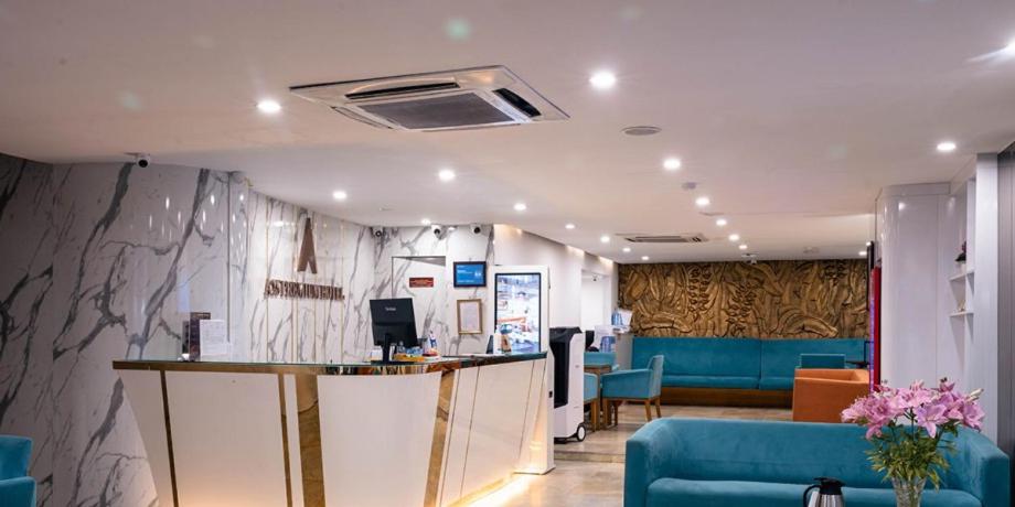 a lobby with a waiting area with a blue couch at A25 Premium Hotel - 12 Ngô Sỹ Liên in Hanoi