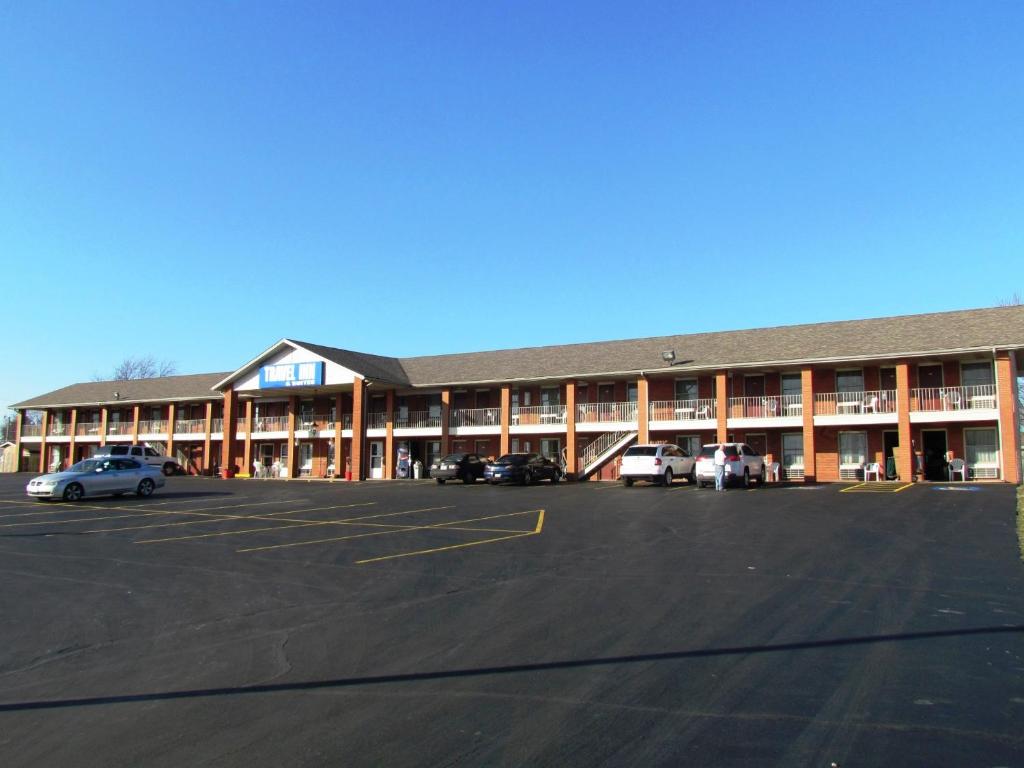 a large building with cars parked in a parking lot at Travel Inn & Suites in Frankfort