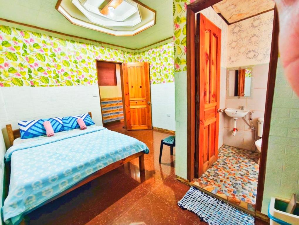 a bedroom with a bed and a bathroom at Mountain Lodge within Town Proper! in Sagada