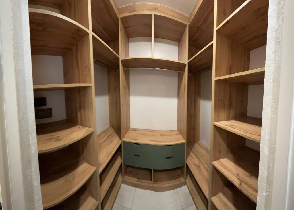 a room with wooden shelves and a table in it at ЖК Модерн in Odesa