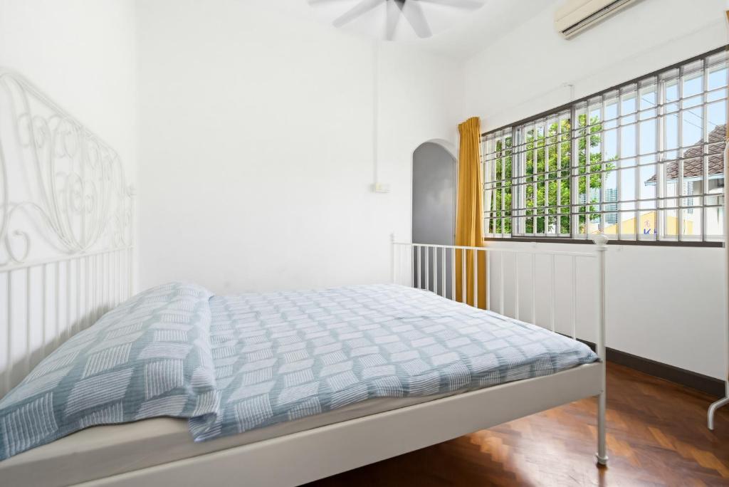 a white bedroom with a bed and a window at Sugar Houz ruum2 in Johor Bahru
