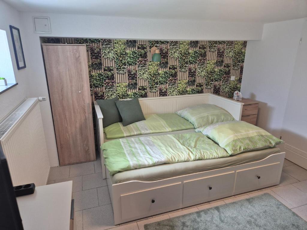 a bed in a room with a wall at Ferienwohnung Weitblick in Steinbach im Taunus