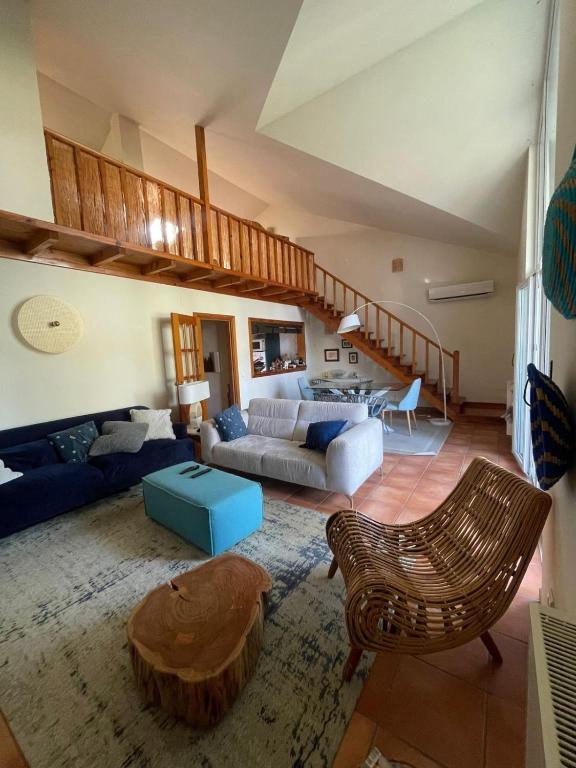 a living room with a couch and a table at Aldeamento Turistico Casas da Comporta in Comporta
