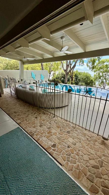 a patio with a fence and a swimming pool at Beachfront Peace Cabin in Oak Beach