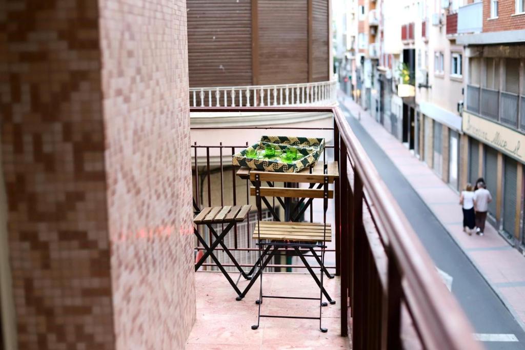 a balcony with a table with fruit on it at Terraza esquina en el centro in Elche