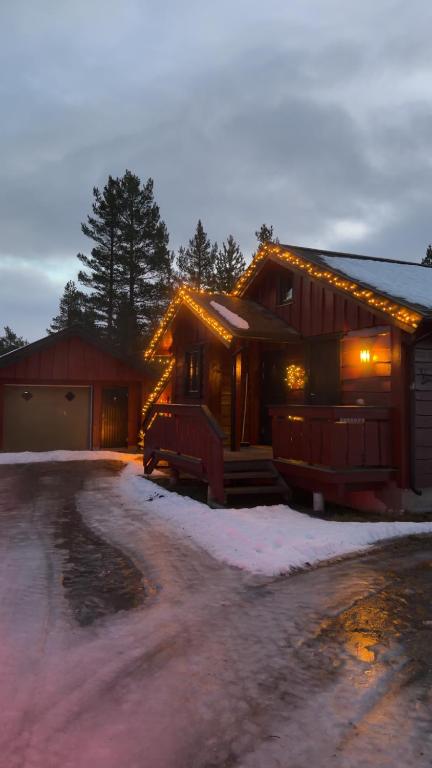 a house with lights on it in the snow at Hansmoen in Bjorli