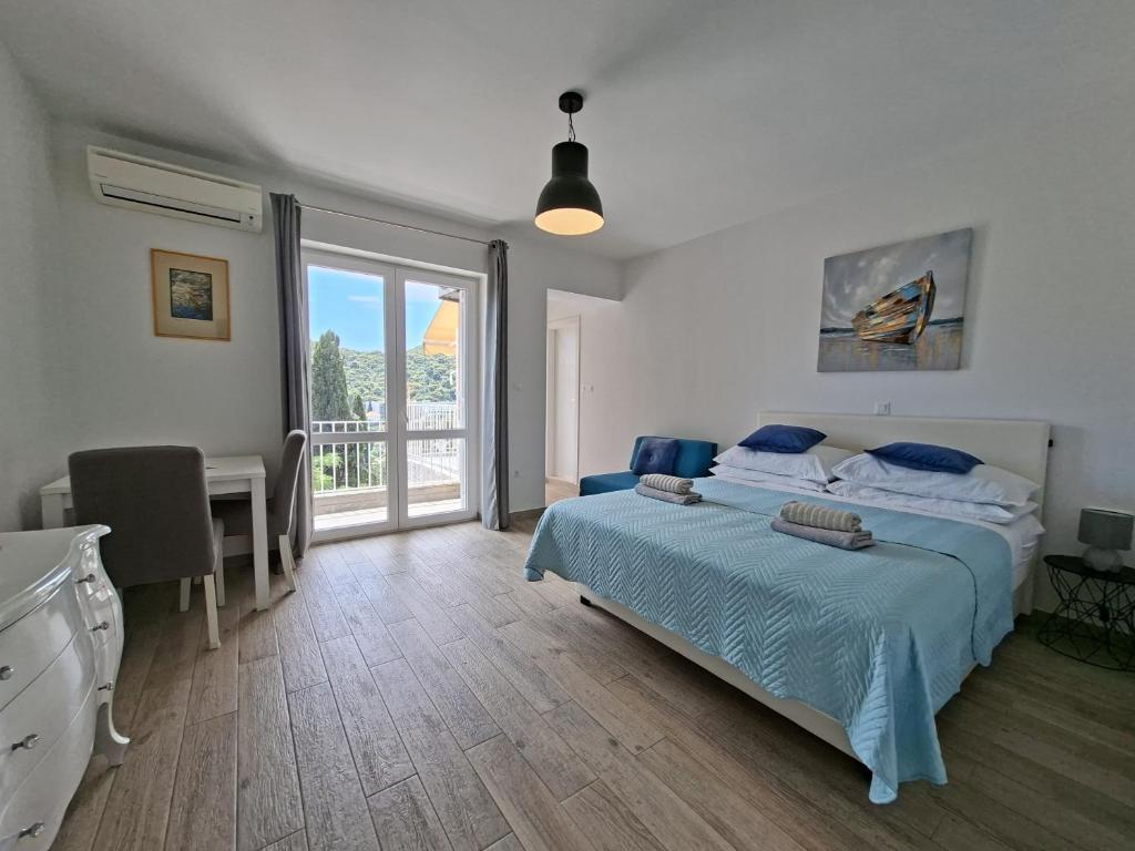 a bedroom with a bed and a desk and a window at Meridiens in Dubrovnik