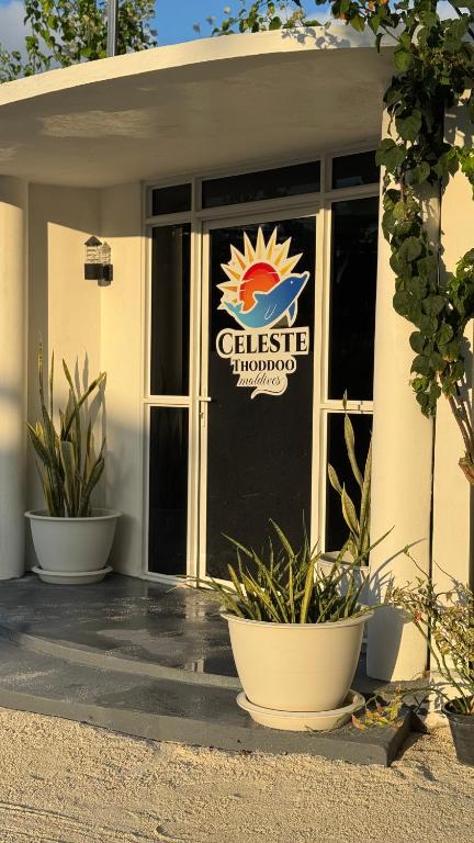 a building with a glass door with a sign on it at Celeste Thoddoo Maldives in Thoddoo