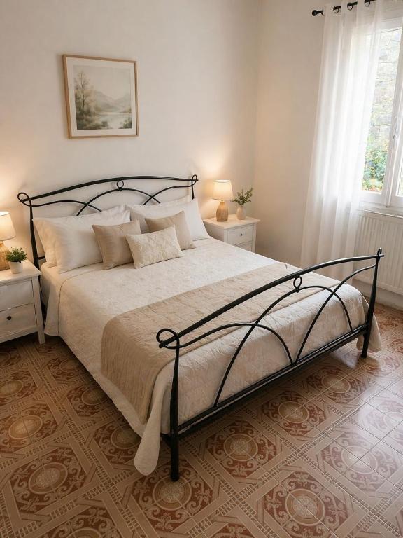 a bedroom with a large bed and two windows at Sa Domo Bonaria - Intero appartamento in Osilo