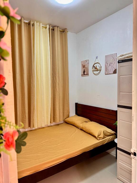 a small bedroom with a bed and a curtain at Athena & Storm the Bay Nook in Victoria