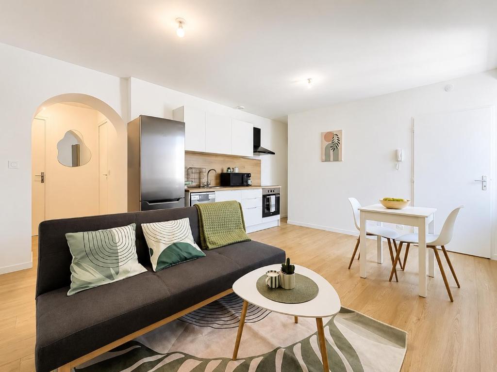 a living room with a couch and a table at 8A - Le Nid in Saint-Rambert-dʼAlbon