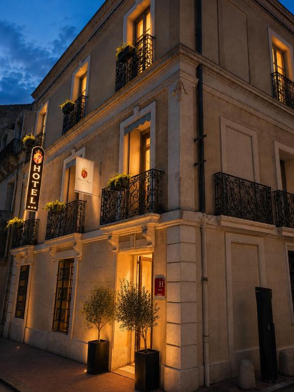 a large white building with windows and potted plants at Hôtel D'Aragon - Place de la Comédie - in Montpellier