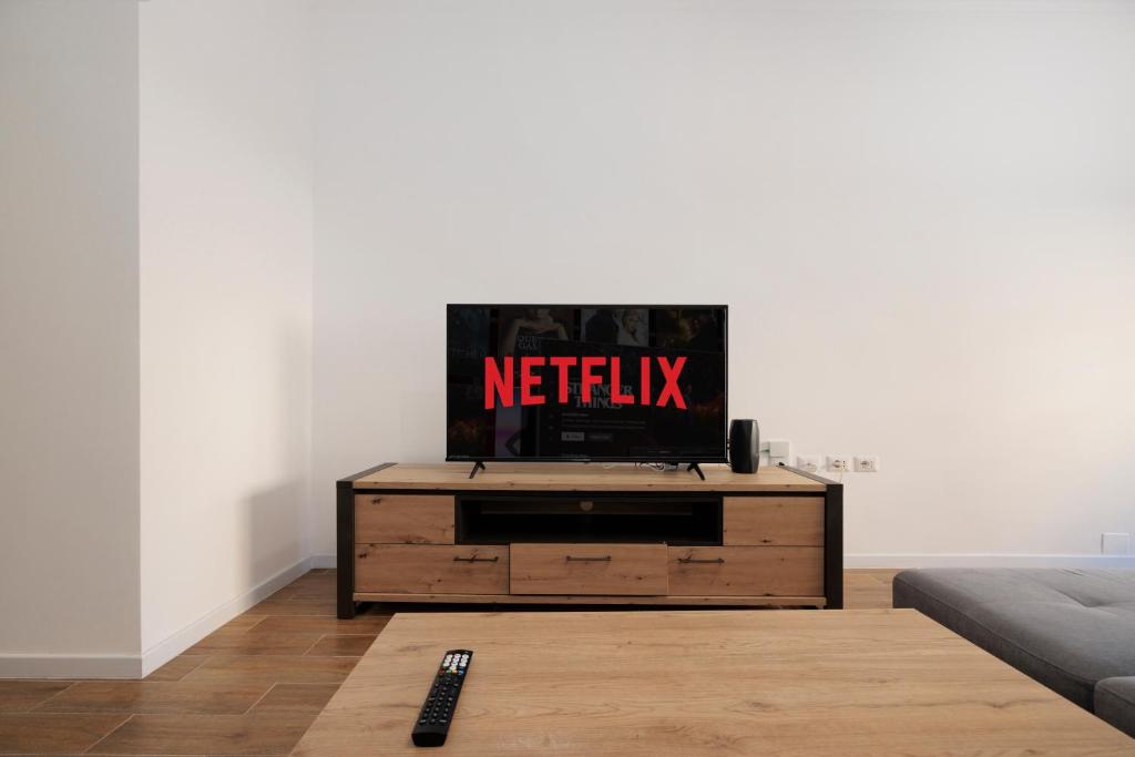 a television sitting on top of a wooden dresser in a living room at ArticOstia in Lido di Ostia