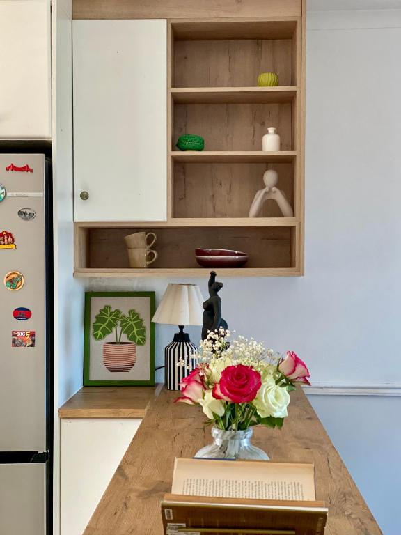 a kitchen with a vase of flowers on a counter at The Willow Escape in Ballito