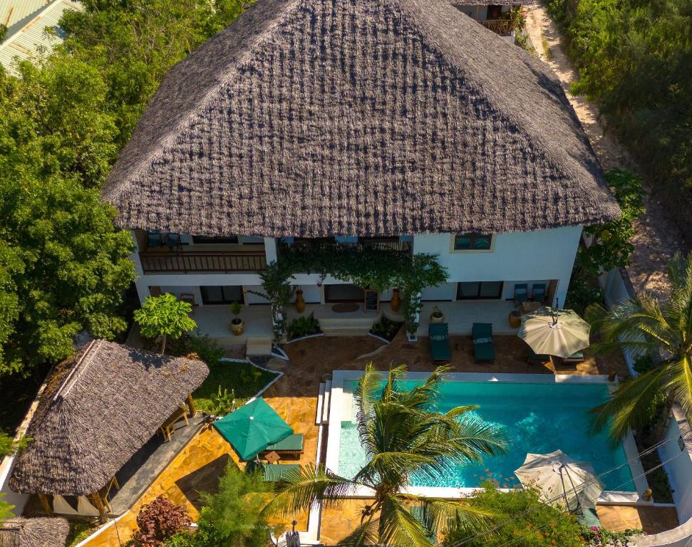 an aerial view of a house with a swimming pool at Daima Villas in Jambiani