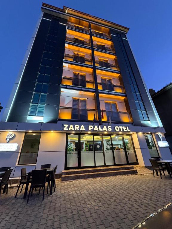 a building with a sign that reads tarra falls outlet at Zara Palas Otel in Zara