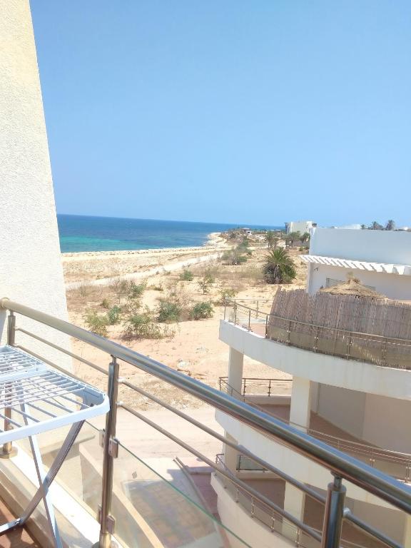 a balcony with a view of the beach at Comfortable Apartment with Sea View – Hergla – 75 m² in Harqalah
