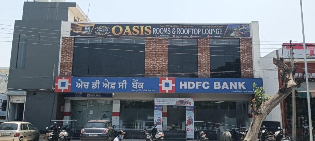 a large building with motorcycles parked in front of it at Oasis hotels in Hoshiārpur