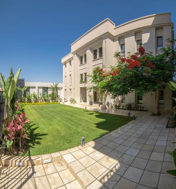 a large house with a lawn in front of it at The Avenue in El Alamein